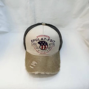 Detail of vintage washed baseball cap with distressed brim and American motor prints