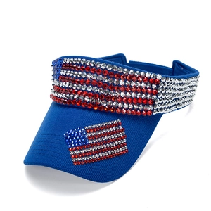 Blue sun visor hat with American flag rhinestone embellishment from a 45-degree angle