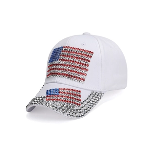 White baseball cap with rhinestone American flag design and sparkling brim detail