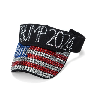 Detailed view of sparkling rhinestones spelling TRUMP 2024 on a black sun visor hat