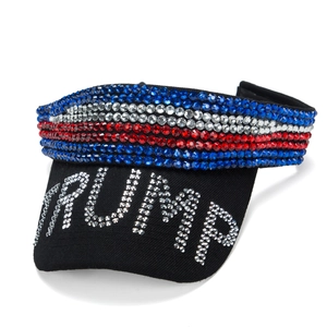 Detail of black sun visor featuring US flag rhinestones and silver Trump lettering