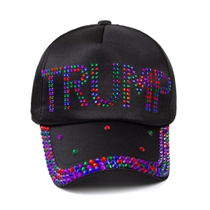 Black satin baseball cap with colorful rhinestones forming Trump text and flag design