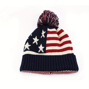 Warm winter knit pompom beanie hat featuring American flag stars and stripes pattern