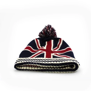 Winter knit beanie with Union Jack flag pattern and pom-pom in navy blue and red