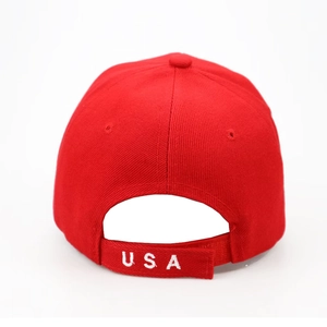 Close-up of red cotton baseball cap back with adjustable strap and white USA embroidery