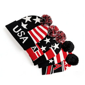Detailed knit texture of winter beanie featuring USA flag pattern and pom-pom topper