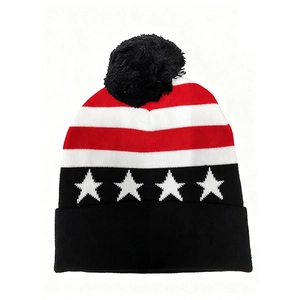 Detailed knit texture of a USA flag pom-pom beanie with star patterns and stripes