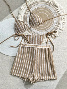 Detail of crochet stripe 3-piece bikini set with high-waisted shorts in earth tones