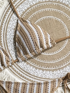 Detailed macro view of the striped crochet knit texture and bohemian fringed bikini material
