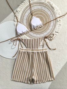 Close-up of three-piece knit striped bikini set with halter top and high-waisted shorts