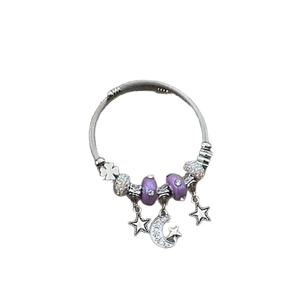 Vintage star and moon charm bracelet with purple beads and silver pendants on white