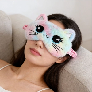 Close-up of a rainbow plush cat sleeping mask worn by a woman for comfortable eye protection