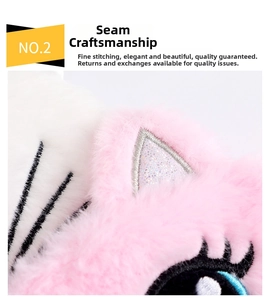 Detail of sewing craftsmanship on pink plush cat sleep mask with fine embroidery