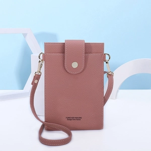 Detail of pink faux leather phone bag with lychee texture and gold metal hardware