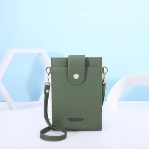 Detail of green lychee leather mobile phone bag with flap snap and shoulder strap