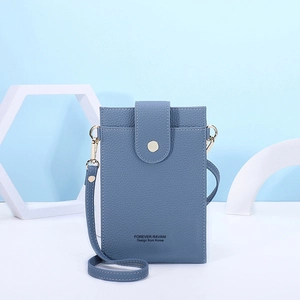 Detailed view of sky blue lychee grain faux leather phone bag with gold metal buckle