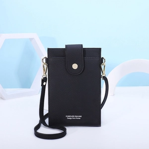 Detailed macro view of black litchi pattern phone bag with gold clasp and logo