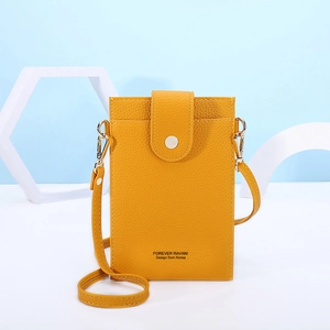Detailed view of yellow lychee leather mini crossbody phone bag with silver metal snap