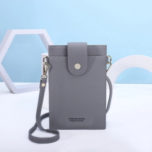 Detail view of grey lychee leather crossbody phone bag with metal clasp and brand logo