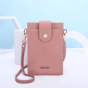 Detail of pink lychee leather phone bag with gold hardware and snap closure detail