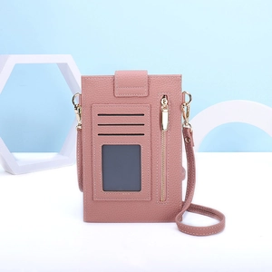 Detail of pink crossbody phone bag showing card slots and clear ID window with gold zippers