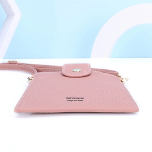 Detail view of pink lychee grain leather phone bag with white stitching and flap closure