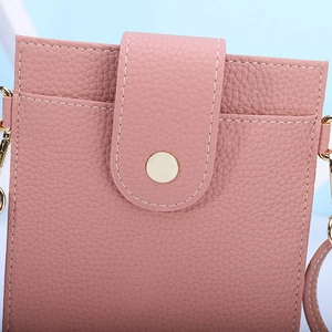 Close-up of pink litchi pattern leather phone bag with gold snap button and contrast stitching
