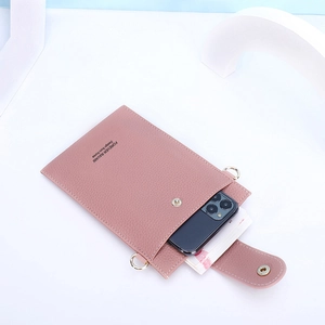 Detail of dust pink faux leather phone bag with magnetic buckle and interior storage space