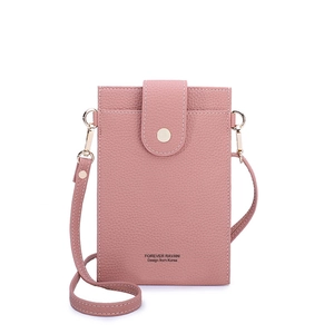 Detailed view of pink pebble grain leather phone bag with magnetic flap and brand logo