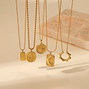 Five-piece gold stainless steel necklace set with star, sun, and moon pendant charms