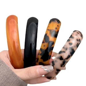 Set of 4 elegant acrylic spring hair clips in amber, black, shell, and leopard patterns