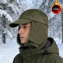 Army green winter trapper hat with ear flaps for men in snowy outdoors
