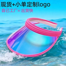 Detail view of pink sun visor with transparent gradient blue brim on ocean background