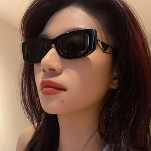 Trendy black rectangular sunglasses featuring cutout metal triangle decor on the frame