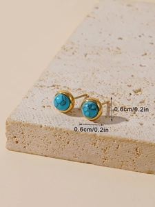 Detailed view of 0.6cm round turquoise stud earrings with gold plating and natural texture