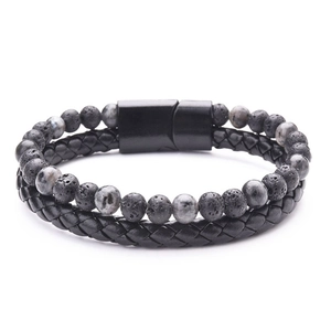 Detail of double-layer men's bracelet with braided black leather, lava stone and magnetic clasp