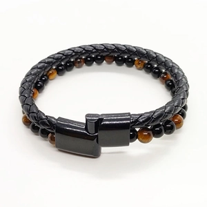 Detail of multi-layer men's leather bracelet with tiger eye beads and magnetic clasp