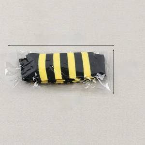 Flat lay of yellow and black striped knit long socks in transparent packaging with size detail