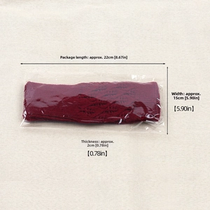 Close-up of deep red knit fingerless gloves in transparent plastic packaging