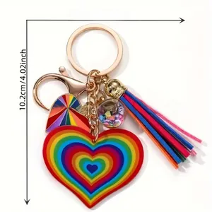 Macro view of rainbow heart pendant with colorful leather tassel and metal lobster clasp