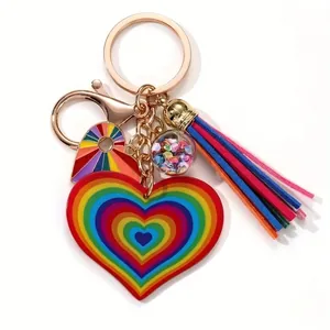 Rainbow heart keychain with colorful tassel, glitter ball, and gold-tone metal clasp