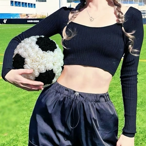 Creative rose football decorative bouquet held by a model on a sunny soccer field