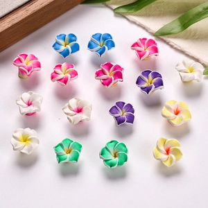 Macro shot of colorful 16mm plumeria flower beads for DIY jewelry and hair accessories