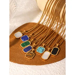 Detailed close-up of luxury gold box chain necklaces with multi-color gemstone pendants