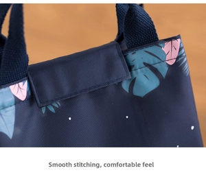 Detailed stitching and tropical monstera print on durable thermal lunch bag handle