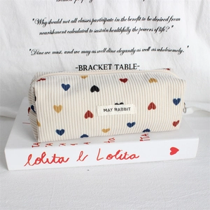Detail of corduroy heart pattern pencil case with textured fabric and zipper pull