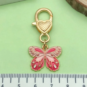 Colorful butterfly keychain with pink enamel and gold-tone metal heart clasp for bags