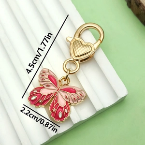 Pink and red butterfly keychain with gold heart clasp, 4.5cm length and high gloss finish