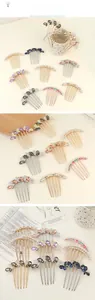 Detail of butterfly metal hair comb with faux pearls and colorful rhinestones