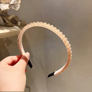 Close-up of handmade champagne crystal beaded headband with woven double-row details